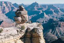 man standing at the top of a canyon