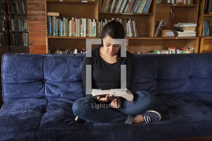 girl reading on a couch 