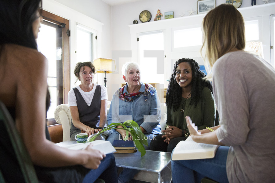 woman's group Bible study having a discussion in a living room 