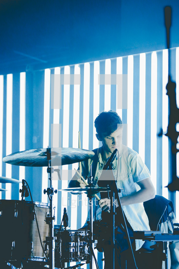 drummer playing drums on stage 