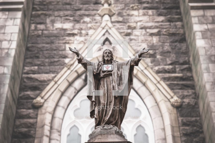 statue of Jesus in front of a church 