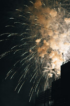 smoke and fireworks bursting in the night sky 