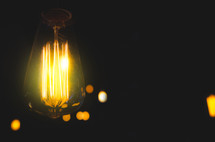 glowing Edison bulb in darkness 