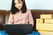 a woman mailing packings from home 