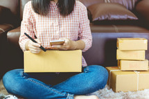 woman mailing packages from home 