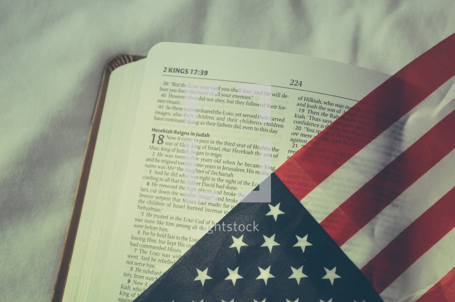 Bible opened to 2 Kings 18 and American flag 