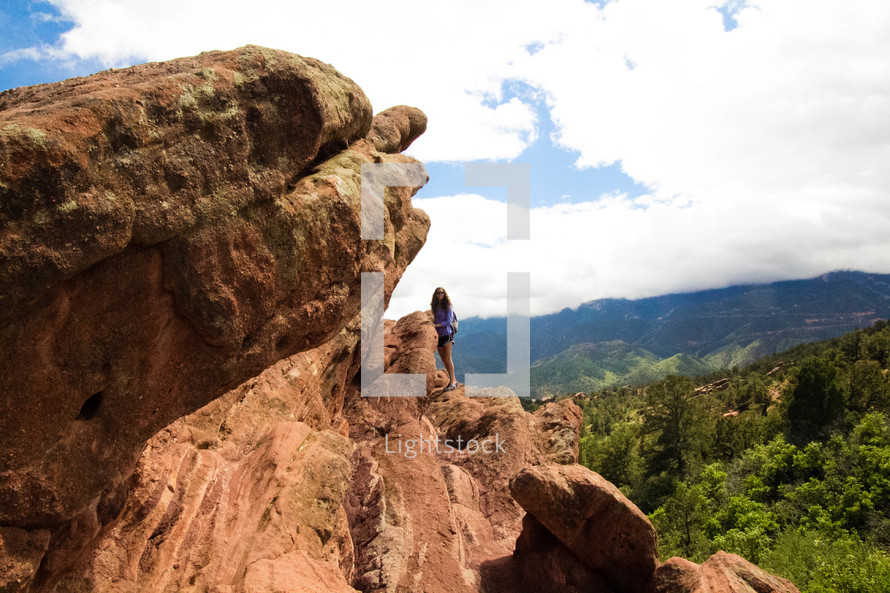 woman climbing on a red rock 