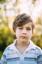 headshot of a boy outdoors 