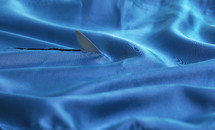 Abstract Knife Shark Fin Above Water Natural Blue Satin Fabric Texture