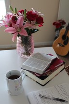 vase of flowers and Bible and journal on a table 
