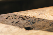 words and names carved into wood 