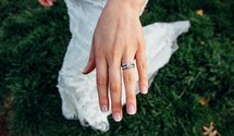 an engagement ring and wedding band on a bride 