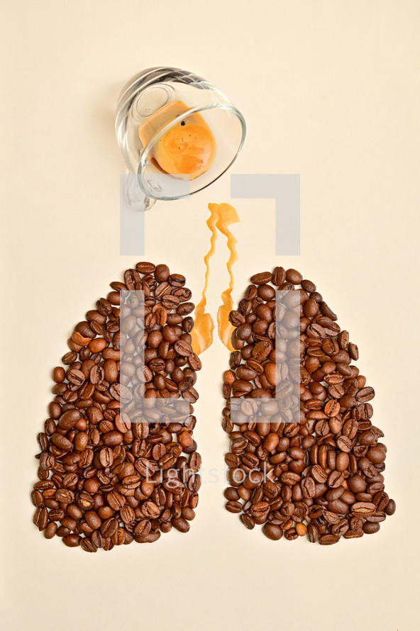 Abstract photo of a dropped espresso cup with coffee beans spilled into the shape of lungs.