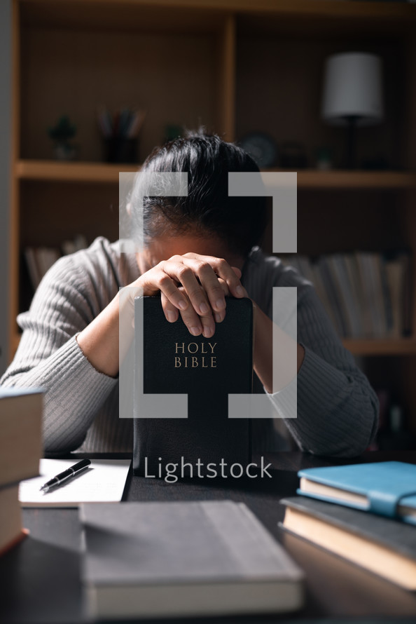 Woman praying with a Bible