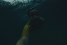 Man swimming under water.