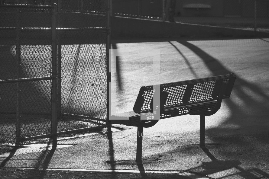 park bench an urban basketball court 