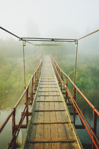 swinging bridge over a river 