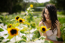 A young woman in a field of sunflowers.