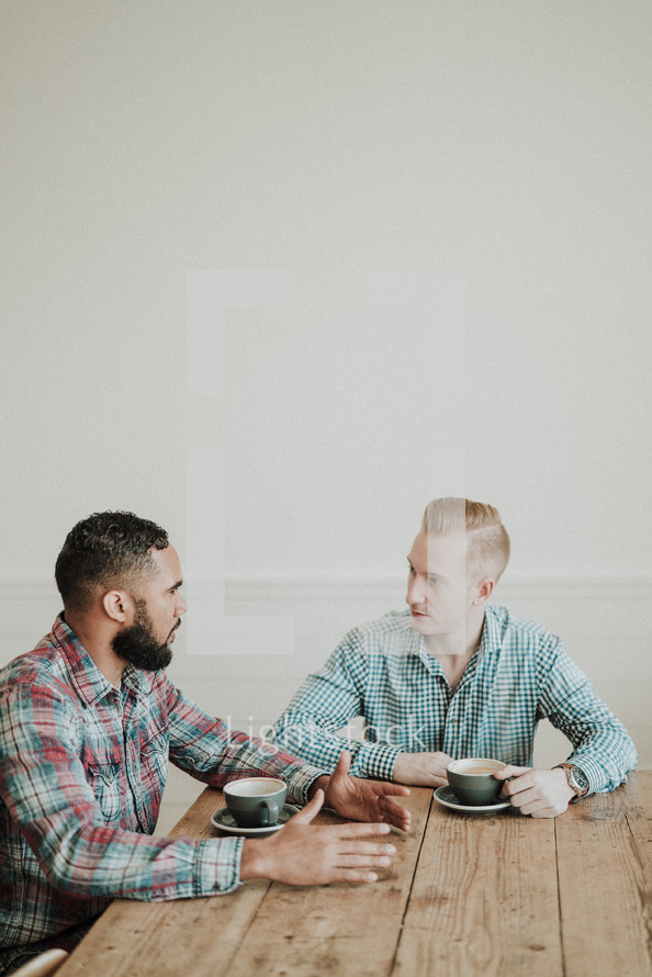two men talking over coffee 