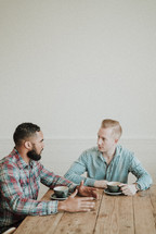 two men talking over coffee 