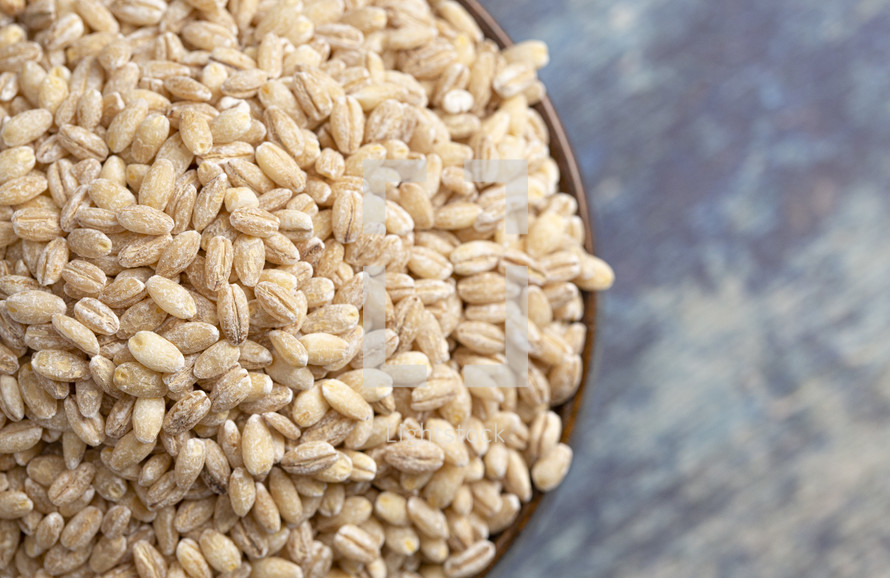 bowl of grains on blue wood background  
