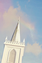 white church steeple and rainbow 