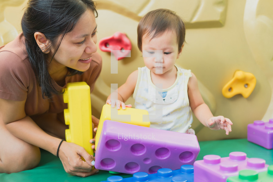 mother and baby playing with blocks 