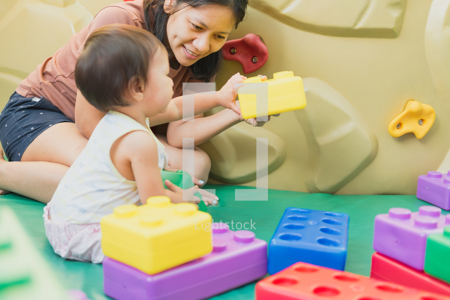 mother and child playing with blocks 
