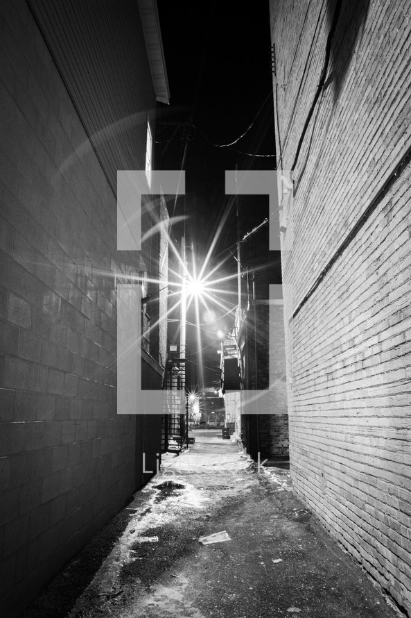 street light shining over a dark alley