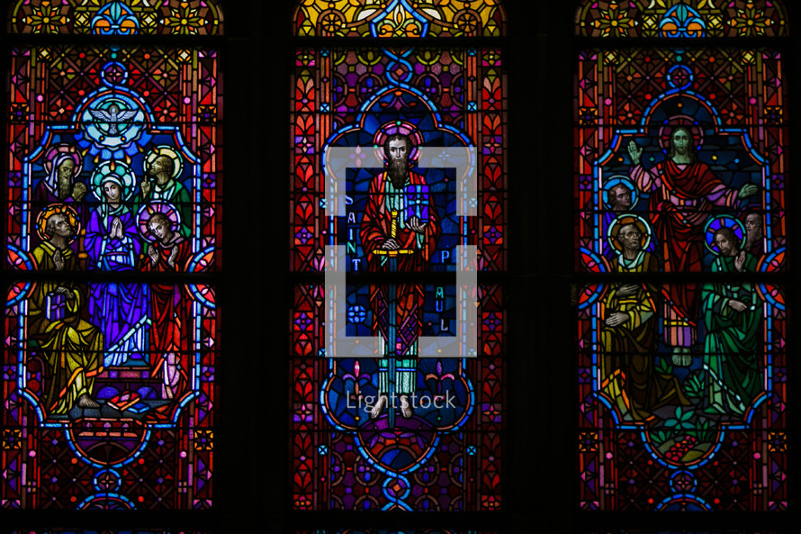 Depictions of Jesus and Mary on three stained glass windows.