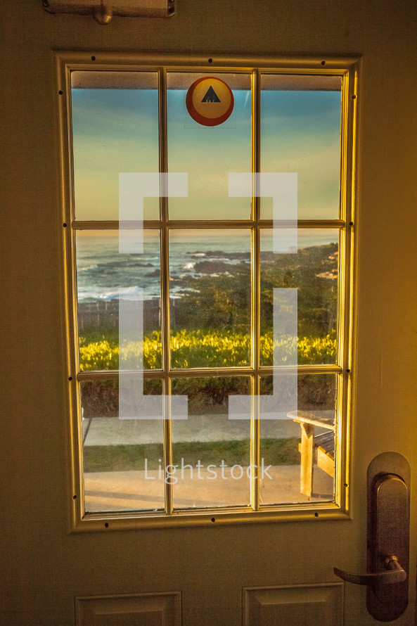 view of the ocean out a door window 
