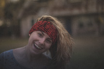 A blonde girl wearing a headband and smiling