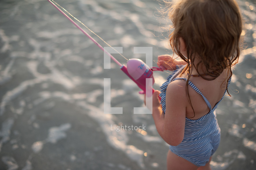 girl child holding a fishing pole 