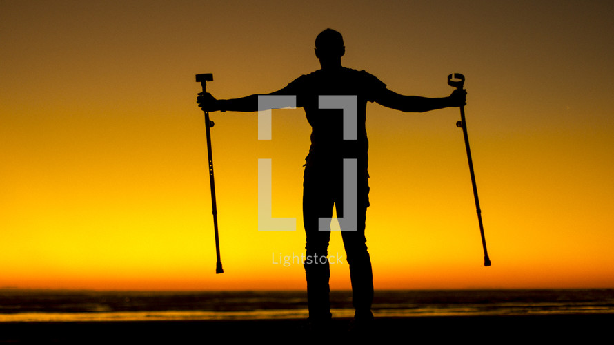 silhouette of a crippled man in arm braces