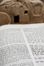 New Testament in Hebrew and English with Tomb in the Background