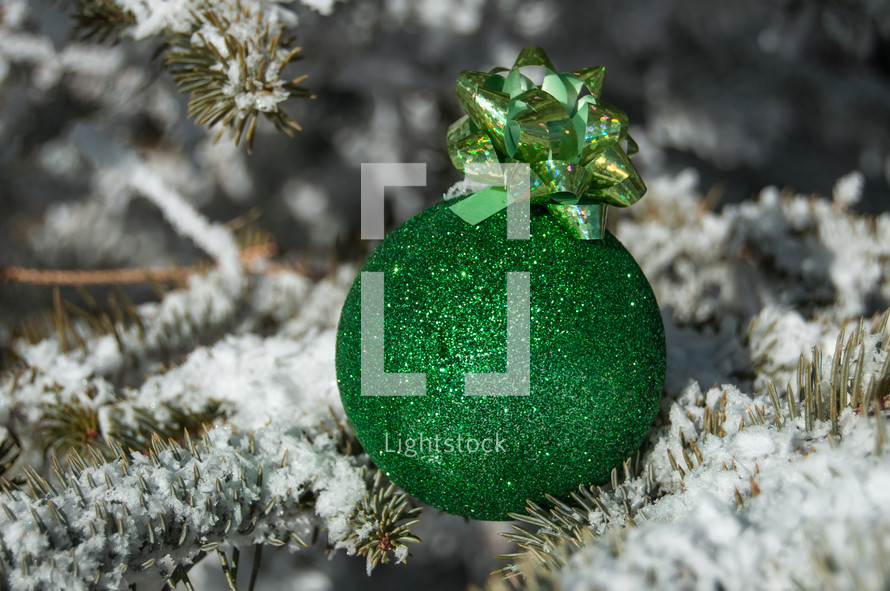 Christmas ornament and snow on pine 