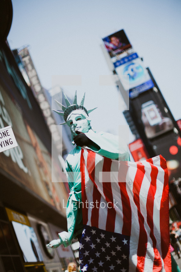 man dressed up like the statue of liberty in Times Square 
