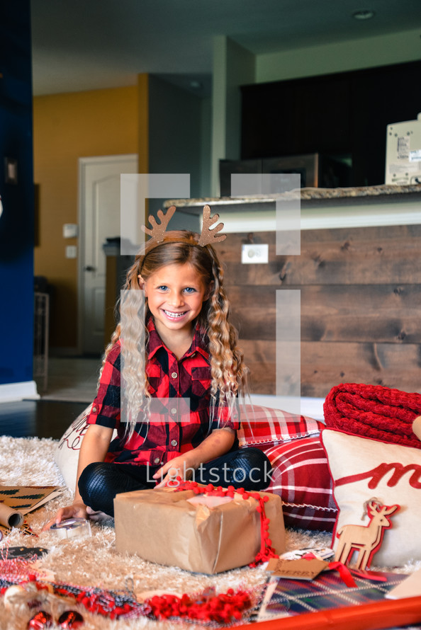 smiling girl with reindeer antlers 