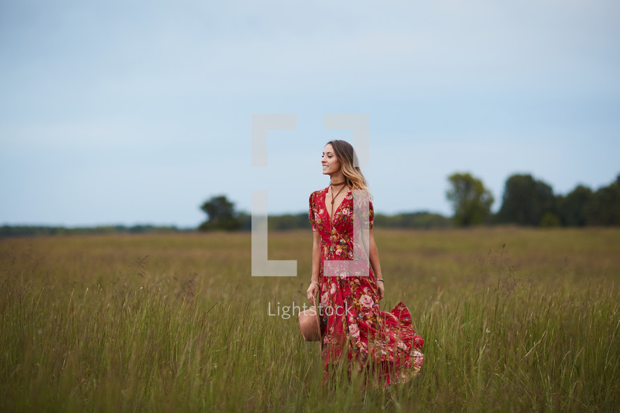 woman walking through a field 