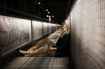 a woman sitting in a tunnel 