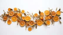 Dried orange garland with leaves on white.