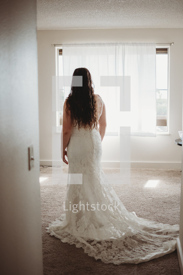 bride standing in a wedding gown 