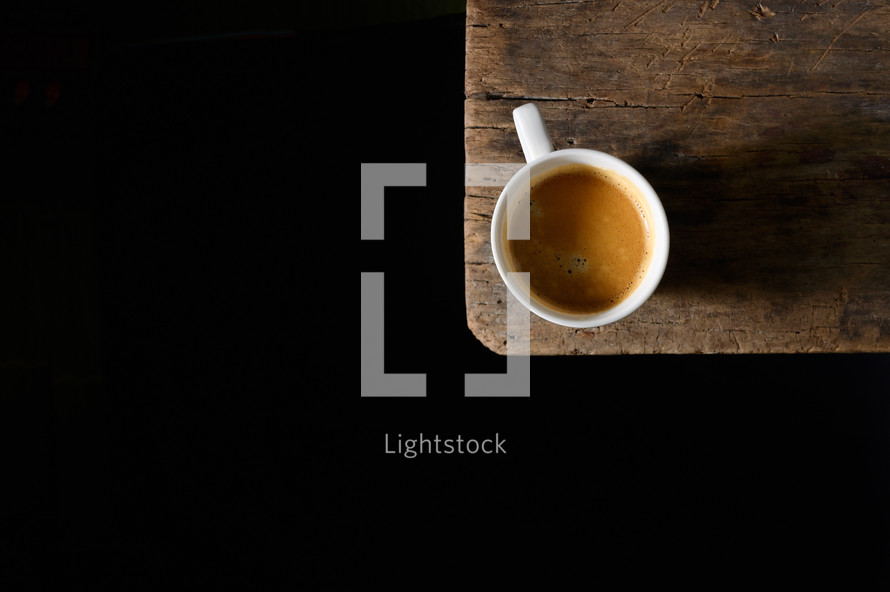 Espresso Cup with Shadow on Wooden Table