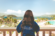 bride looking over a balcony at a resort 