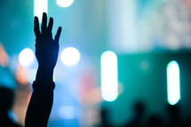 silhouette of a raised hand in praise. 