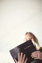 Woman reading a Bible.