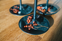 dried berries on candlesticks 