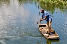 man fishing with a rustic fishing pole 