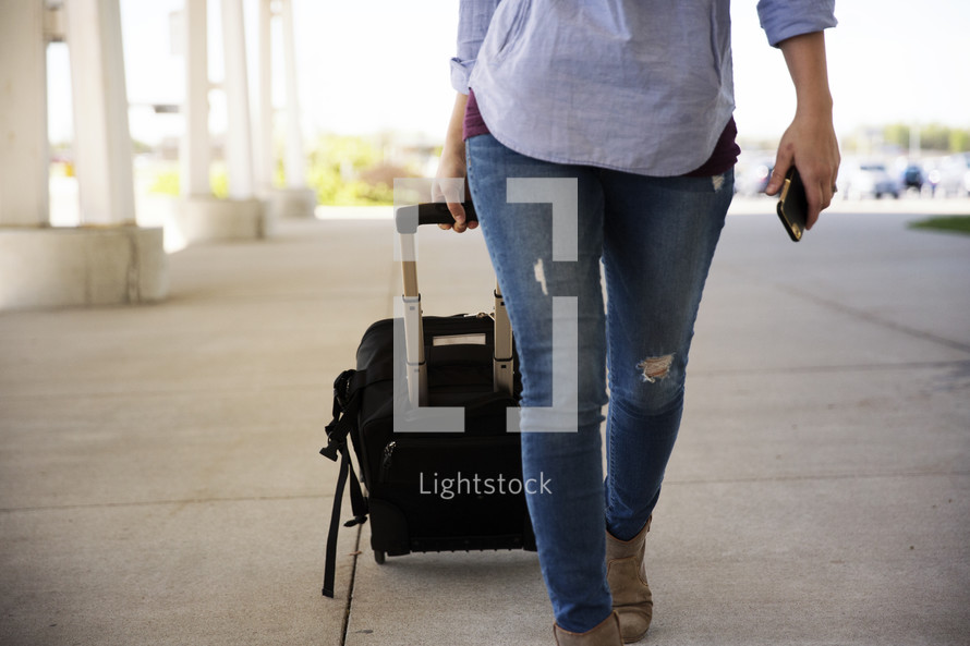 woman pulling luggage 