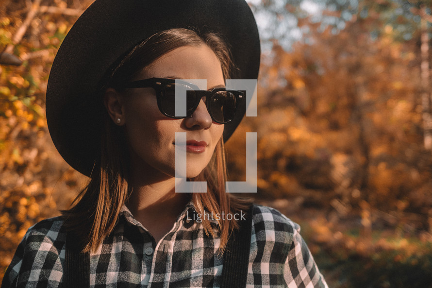 Hipster woman portrait, autumn park, beautiful golden nature. Lifestyle, hat.